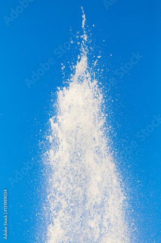 water splashing from the fountain in the background of blue sky