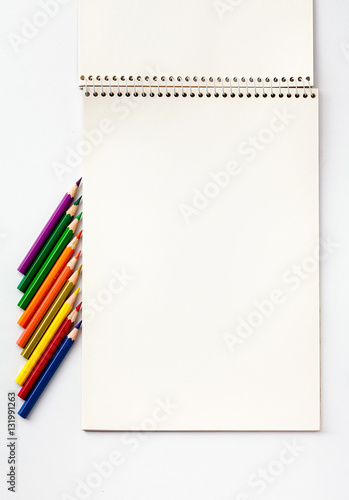 Note and color pencils on a white