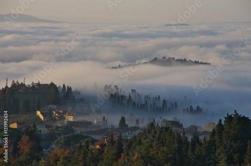 Fog in the valleys near Florence at sunrise.