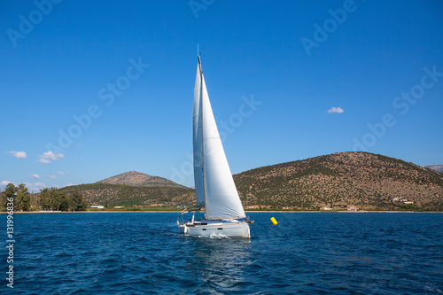 Sailing ship luxury yacht boat with white sails in the Sea.