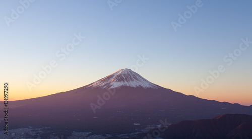 Top of Mt. Fuji and sunrise sky in autumn season