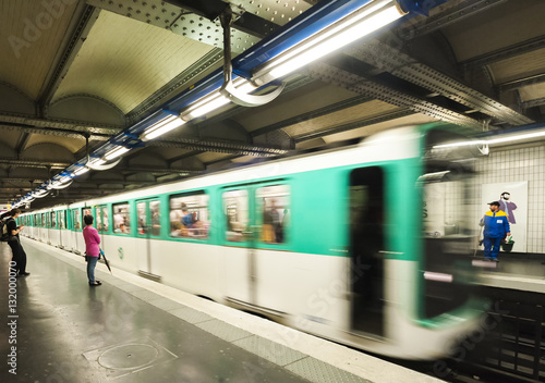 Paris Metro Train approaching a station at speed.