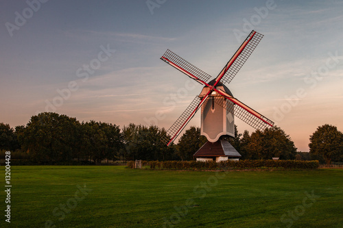 A historic windmill at sunset 