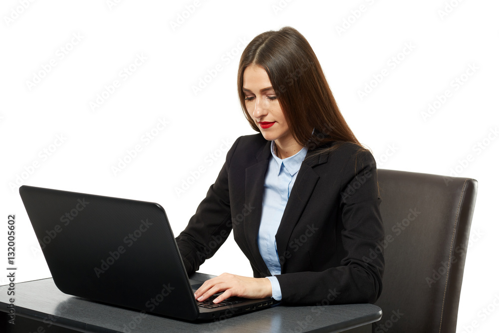Young businesswoman at her desk with a laptop Young businesswoman at her desk with a laptop