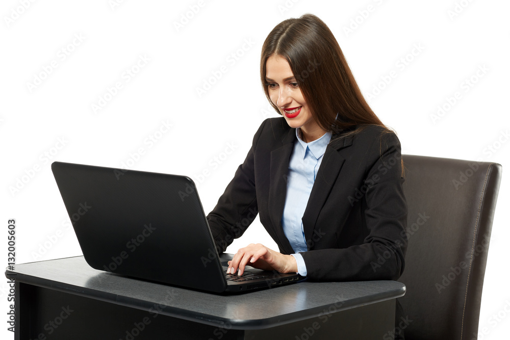 Young businesswoman at her desk with a laptop Young businesswoman at her desk with a laptop