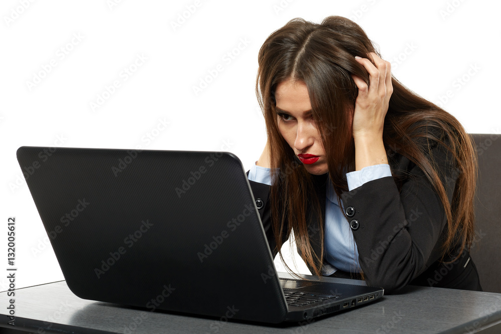 Frustrated young businesswoman at her laptop Frustrated young businesswoman at her laptop