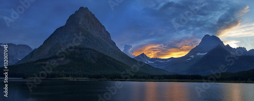 A dramatic sunset is drawing to a close over Mount Grinnell and Swiftcurrent Lake in teh Many Glacier part of Montana's Glacier National Park photo
