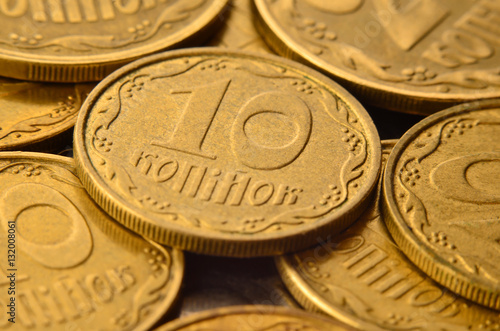 Detailed macro shot of Ukrainian money coins in the form of cash cents. Ukrainian kopeck with detailed metal texture and relief ornament in the form of plants.