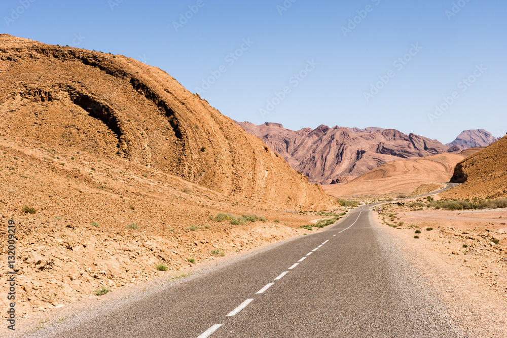 Road with rolled mountains between Tagmoute and Tata, Morocco
