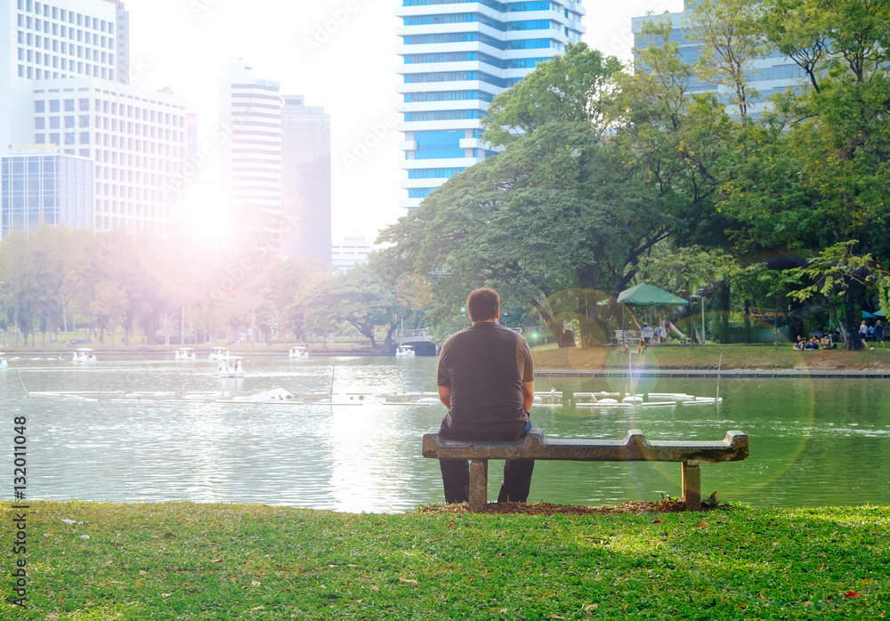 Man sitting on bench with flare light and astia tone
Man sitting on bench with flare light and astia tone