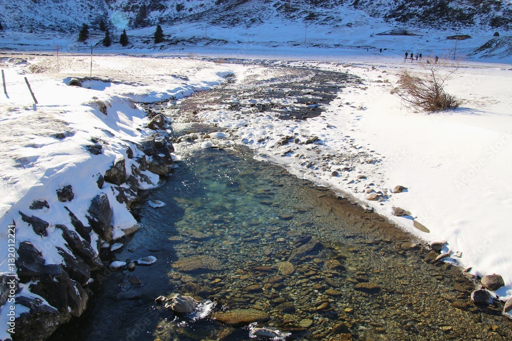 Creek in the mountains in winter, at the head of the Gastein valley, Austria, Europe. In the region Nassfeld, Sportgastein, 1500 m above sea level.