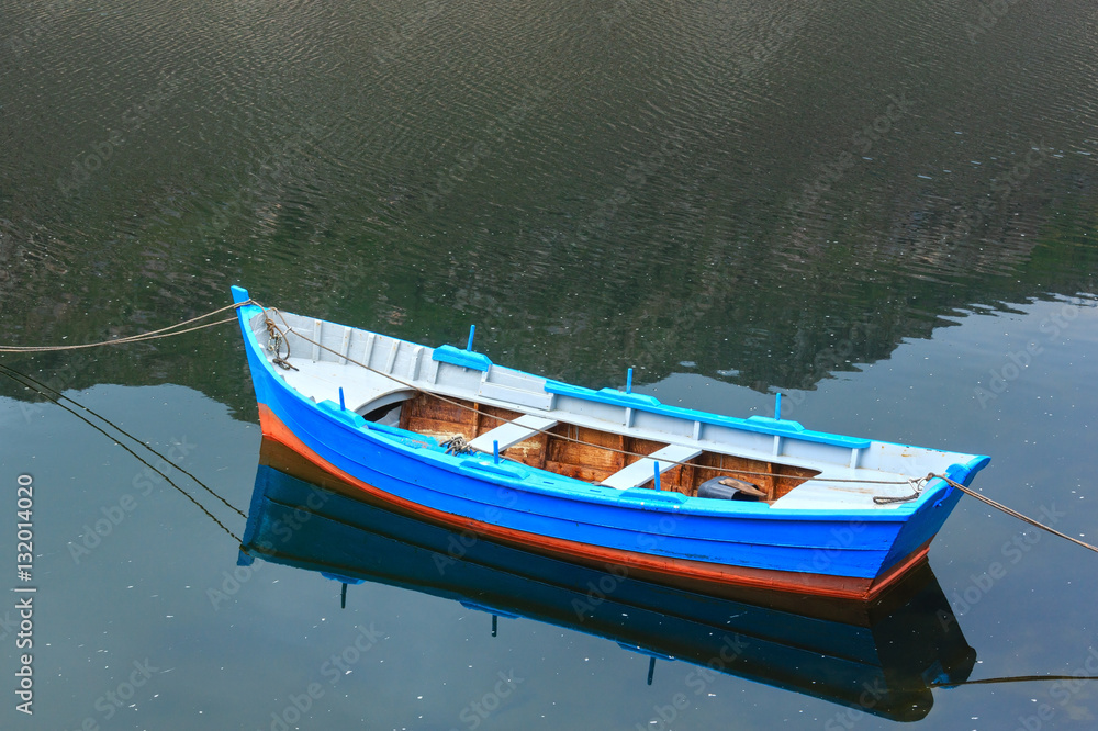 Boat on lake water surface.