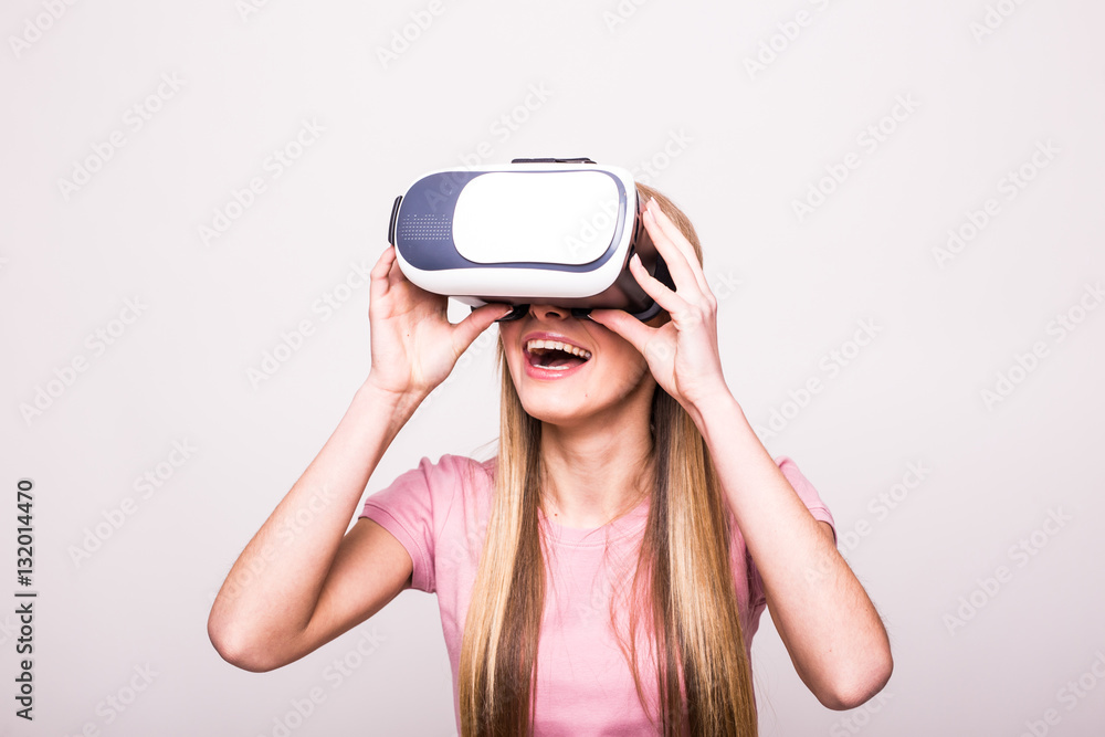 Joyful young girl using a VR headset and smiling isolated on white background Joyful young girl using a VR headset and smiling isolated on white background