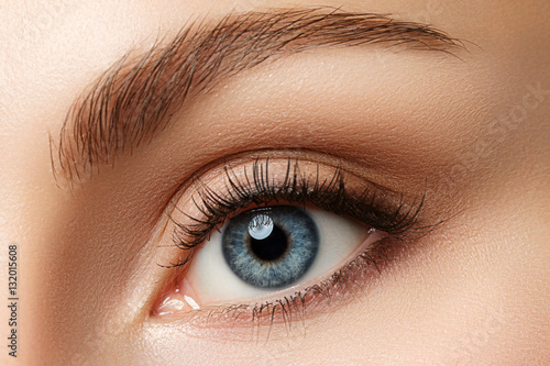 Fototapeta Naklejka Na Ścianę i Meble -  Close up view of beautiful blue female eye