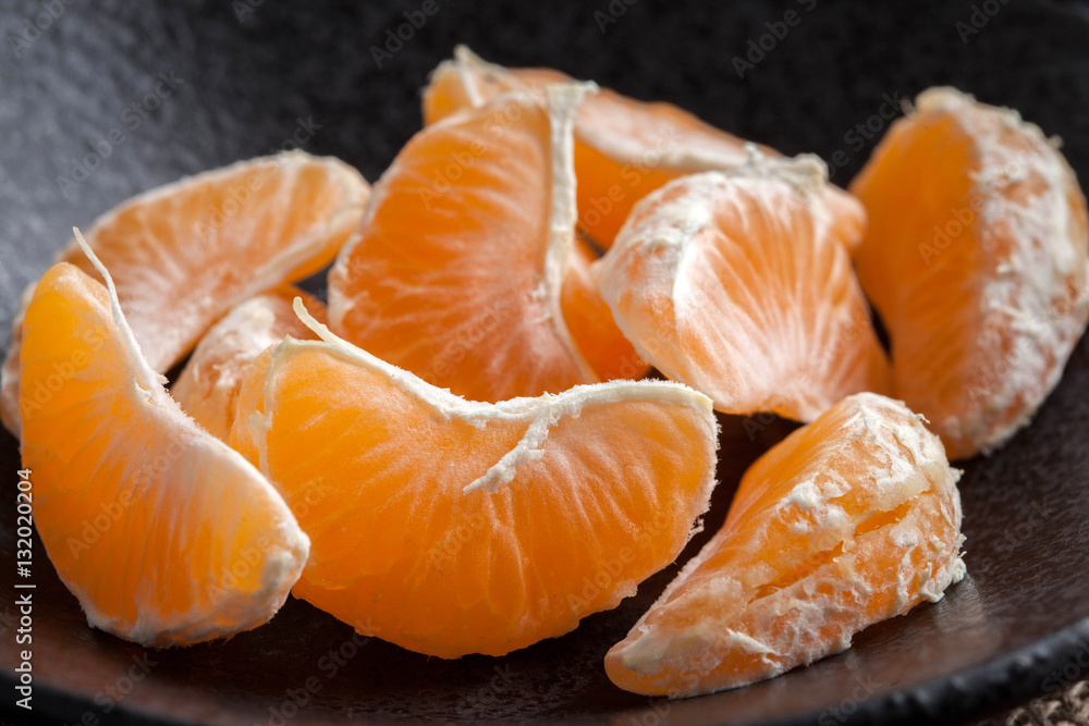 Peeled tangerine on the wooden table. Peeled tangerine on the wooden table.