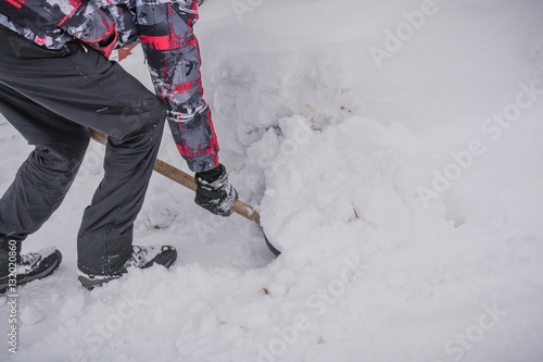 The man shovels away snow