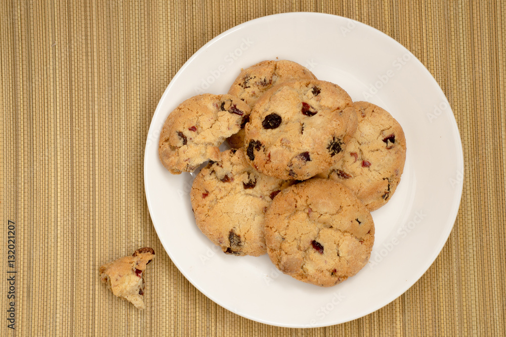 Cookies with raisins on the plate. on straw mat Cookies with raisins on the plate. on straw mat