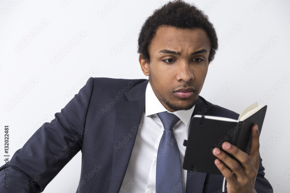 Serious African American man with a notebook Serious African American man with a notebook