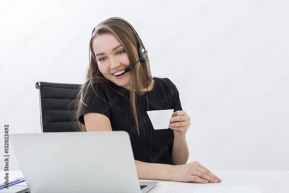 Call center employee smiling with coffee Call center employee smiling with coffee