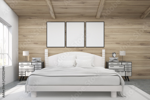 Double bed in a wooden room with posters