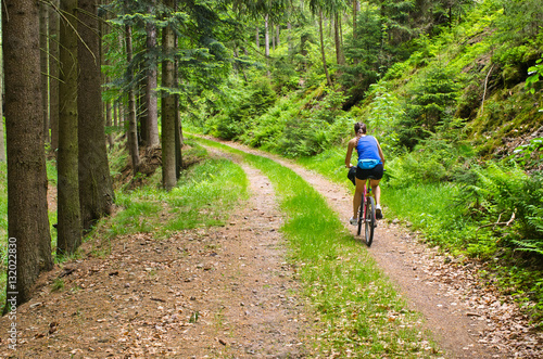 Woman bicycling in the woods