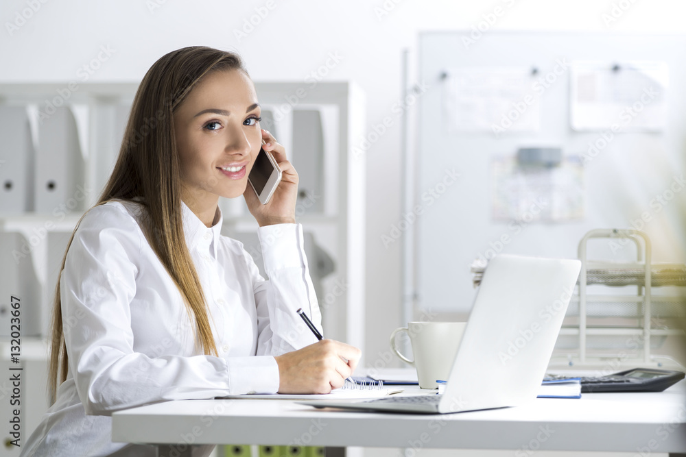 Woman in white blouse on cell phone Woman in white blouse on cell phone