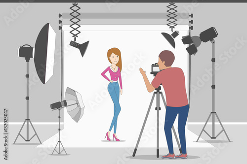 Model in photo studio. White background with lights and cameras. Photographer making photos. Fashion clothes.