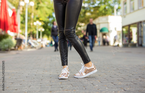 Woman with shiny sneakers