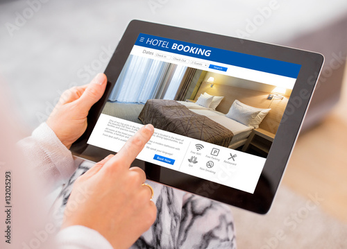 Person booking hotel room on tablet