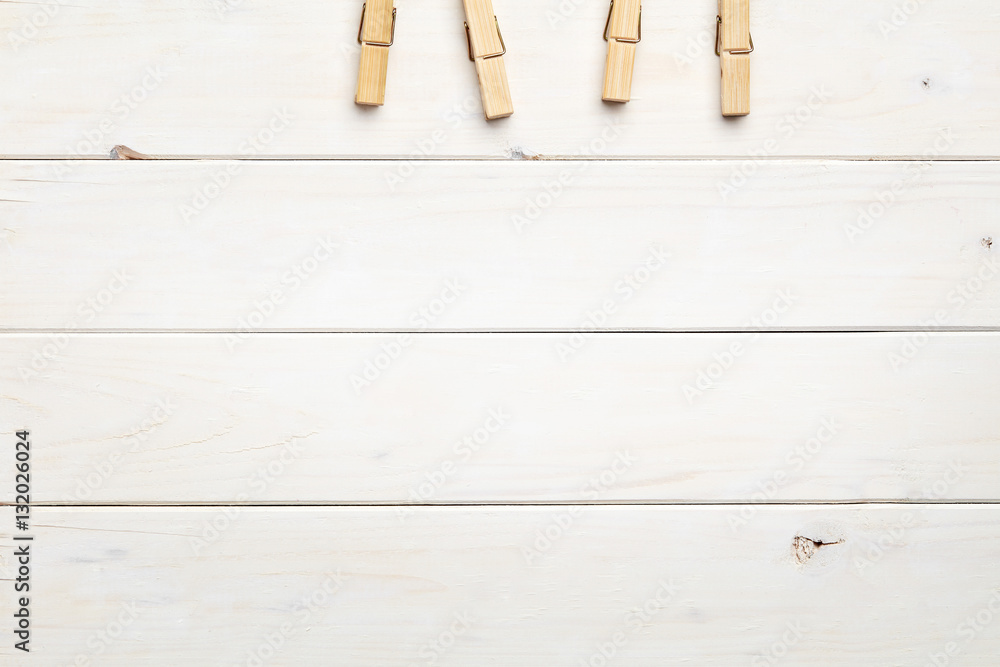 Empty white wooden background with clothes pegs Empty white wooden background with clothes pegs