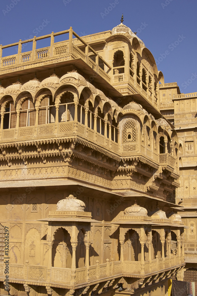 Fototapeta premium Intricately carved walls and balconies of the honey coloured Jaisalmer Palace in Jaisalmer Fort in Rajasthan, India. 17th century Rajput architecture. 