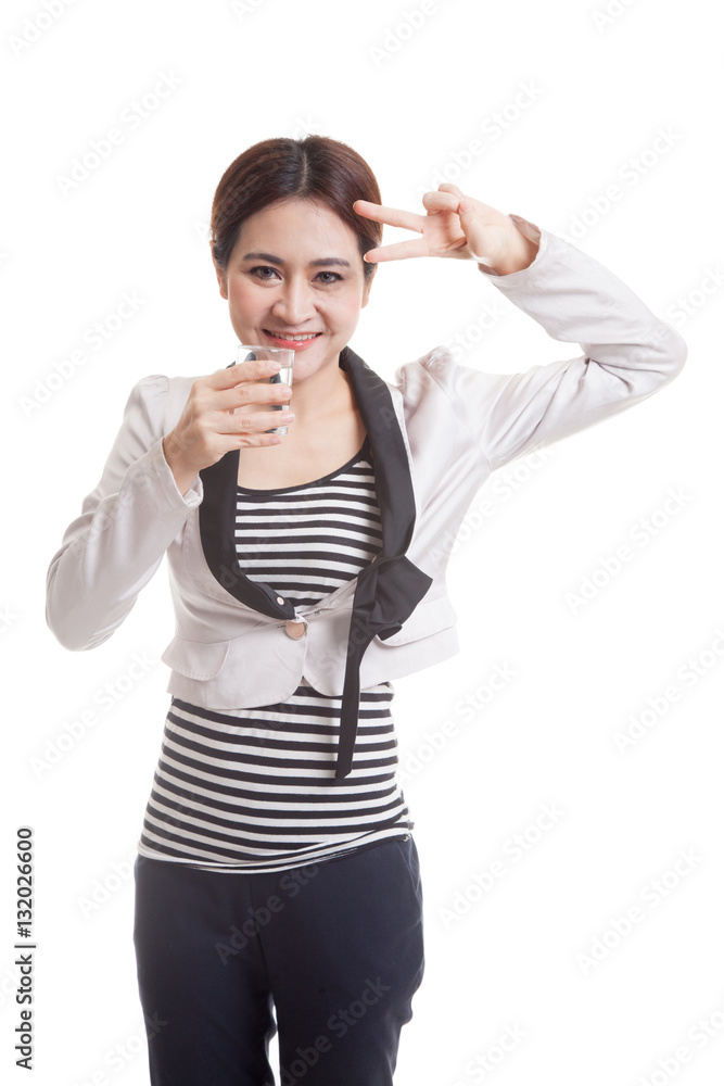 Young Asian woman show victory sign with a glass of drinking wat Young Asian woman show victory sign with a glass of drinking wat