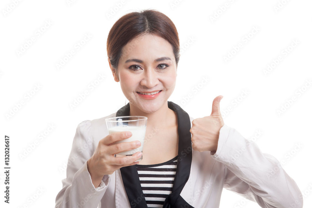 Healthy Asian woman drinking a glass of milk thumbs up. Healthy Asian woman drinking a glass of milk thumbs up.