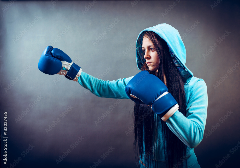 Boxer woman during boxing exercise making direct hit