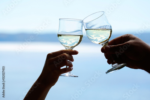human hands with wine glasses