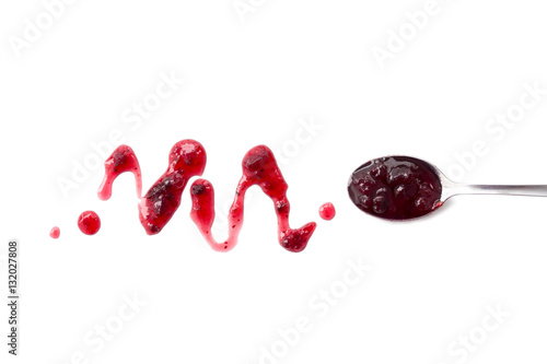 Berry jam blot and spoon with jam isolated on white