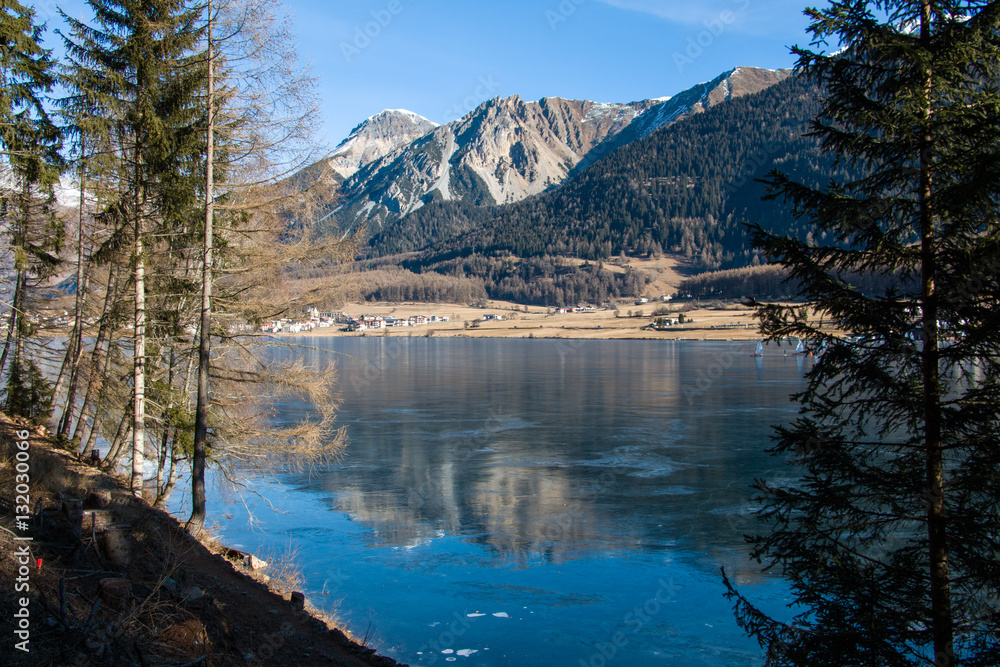 Frozen Haidersee (lake) St. Valentin, Vinschgau, South Tyrol, Italy