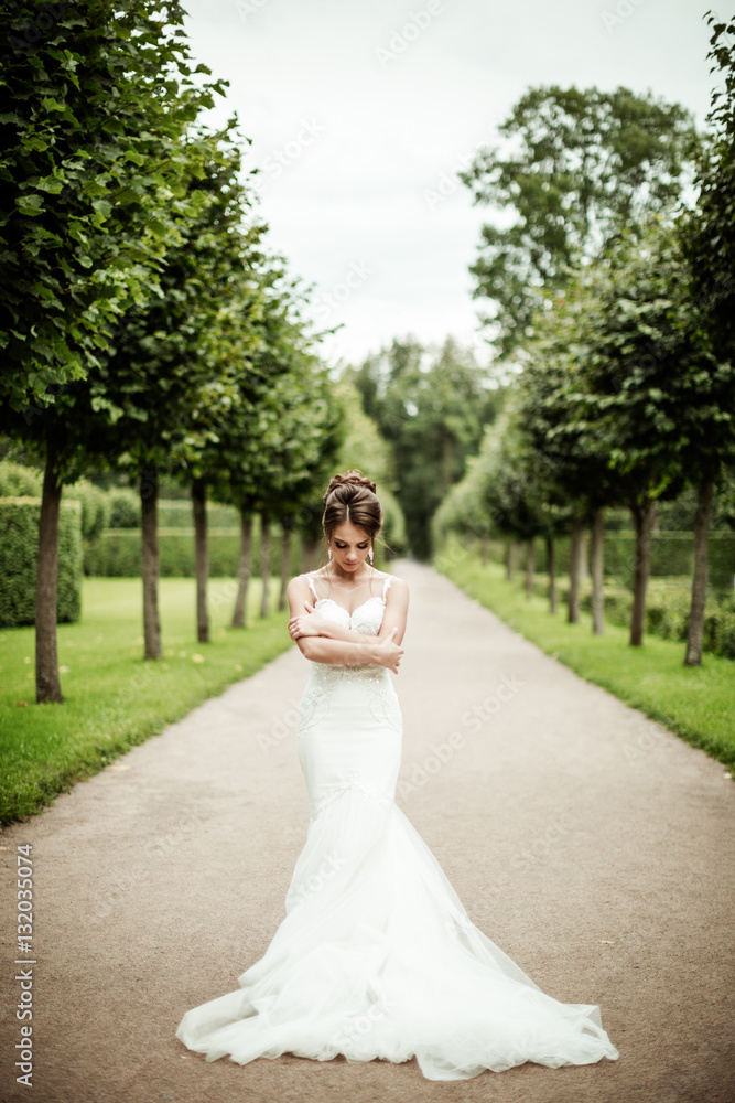 beautiful young bride standing in a park beautiful young bride standing in a park