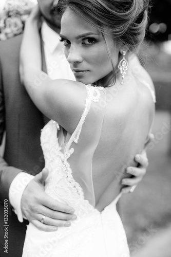 beautiful young bride standing in a park 