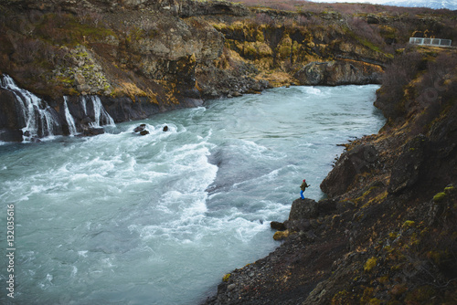 Man Throwing Stone in Water