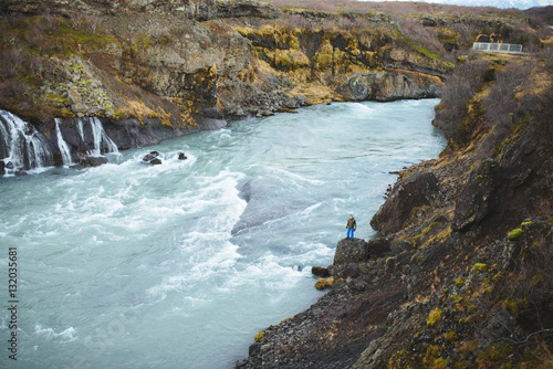 Man Standing on Stone at River