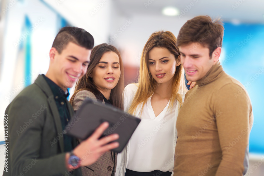 Fototapeta premium Four people are choosing digital tablet in store