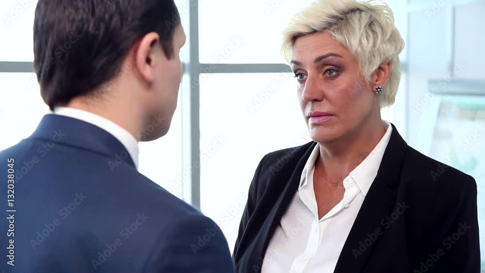 The Hard Position of Financial Director/We see a dispute between two businessmen: man and woman. Their conversation takes place in the bright and airy lobby business centers The Hard Position of Financial Director/We see a dispute between two businessmen: man and woman. Their conversation takes place in the bright and airy lobby business centers