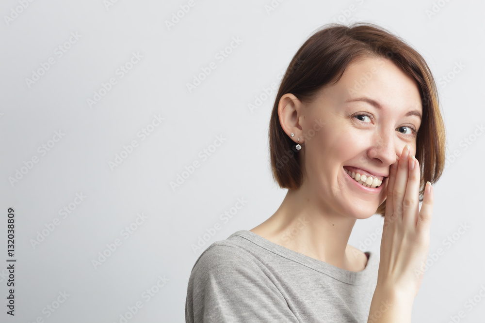 Girl shares with secret whispering, covering mouth with hand Girl shares with secret whispering, covering mouth with hand