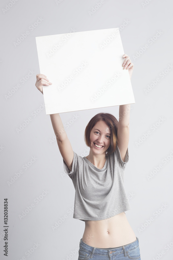 Beautiful caucasian girl holding a blank poster for text or ad. Beautiful caucasian girl holding a blank poster for text or ad.