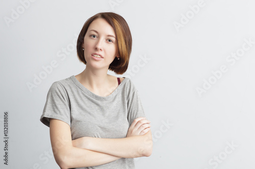 Beautiful and skinny girl with displeasure crossed her arms over