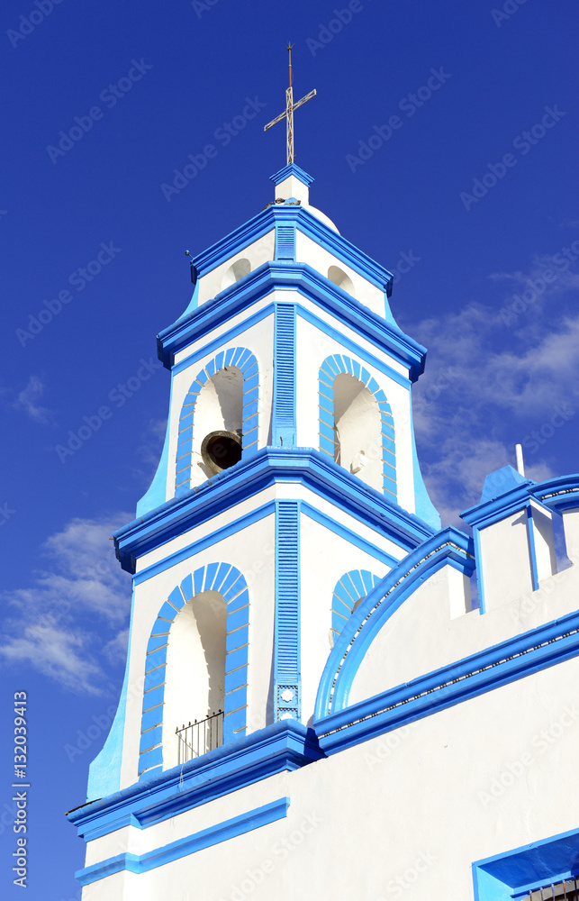 Colorful Church with blue sky background located near borders of Veracruz and Puebla, close to Pico de Orizaba, Iztaccihuatland Popocatepetl volcanoes, Mexico