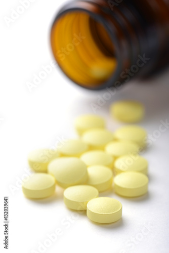 pills in pill bottle on white background