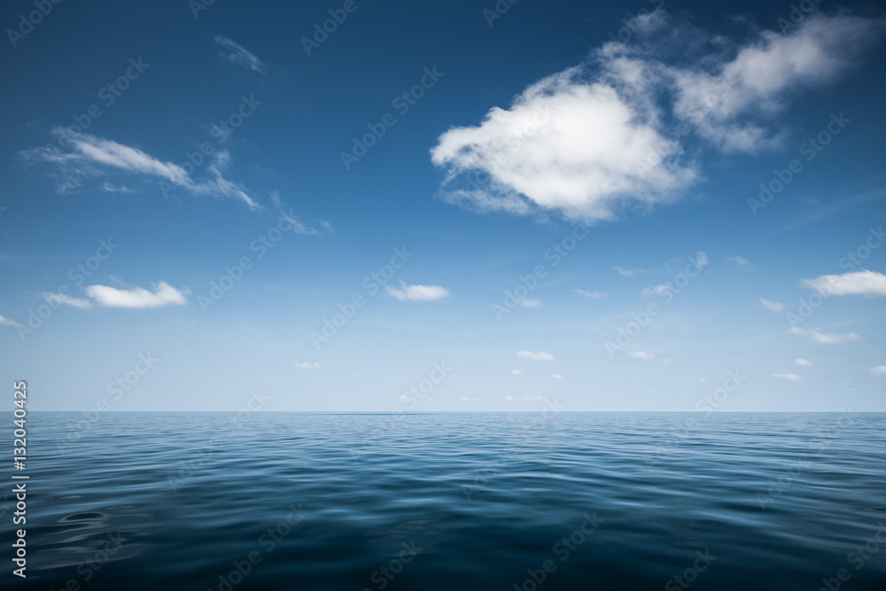 Calm sea with blue clear sky and clouds