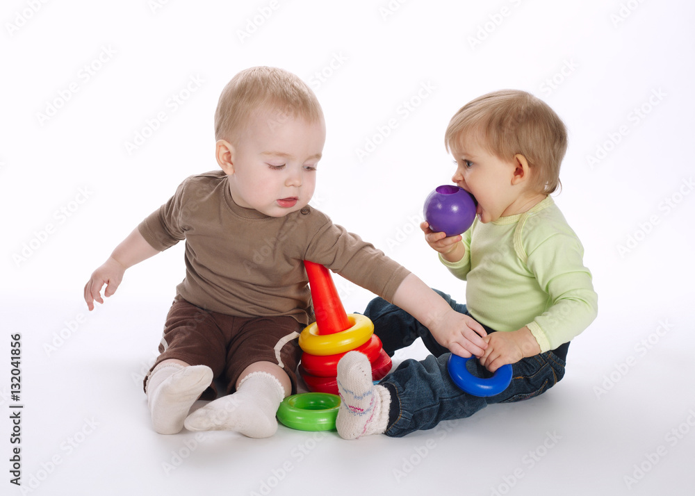 two beautiful children playing with pyramide two beautiful children playing with pyramide